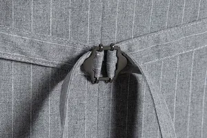 Detailed close-up of a grey pinstripe suit vest showing the back adjustment cinch buckle