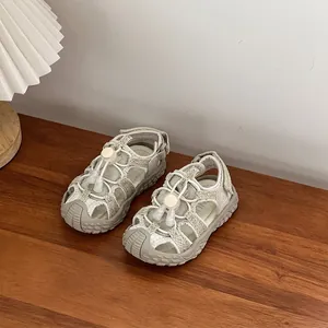 Detail view of breathable grey children's sports sandals with toggle laces and anti-collision toe