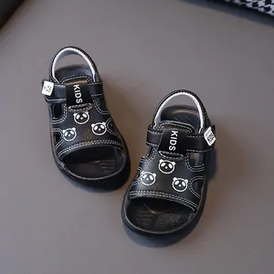Close-up detail of black toddler sandals with cute panda patterns and non-slip soft soles