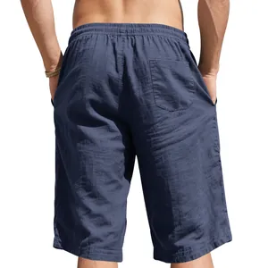 Back view of men's loose navy linen shorts showing elastic waist and back pocket detail
