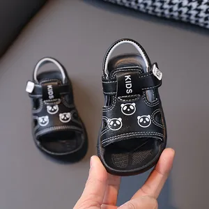 Detail view of black toddler sandals featuring cute panda prints and adjustable straps.