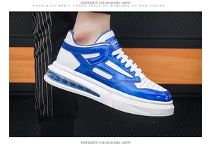 Close-up of white and blue men's athletic sneaker featuring a visible air cushion sole.