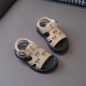 Detailed view of khaki toddler sandals featuring cute panda prints and KIDS velcro straps