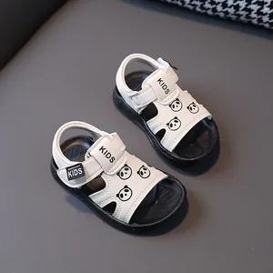 Close-up of white toddler sandals with cute panda cartoons and soft anti-slip soles