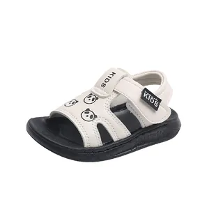 Close-up of toddler white sandals with a cute panda pattern and black soft soles