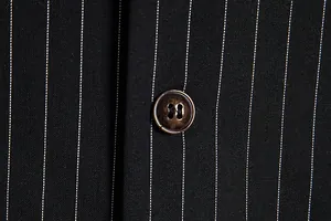 Macro view of pinstripe fabric texture and resin button on a men's retro suit vest