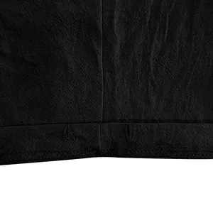 Detailed macro view showing linen fabric texture and stitching on black casual shorts
