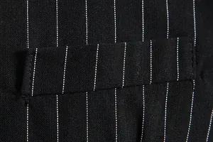 Macro view of pinstriped fabric and pocket detail on a black vintage men's vest