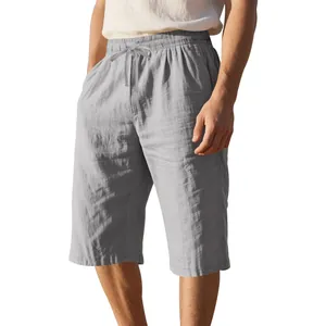Close-up detail of men's lightweight gray linen drawstring shorts with a loose casual fit