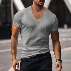 Close-up view of the slim-fit grey V-neck t-shirt worn by a model in an urban street setting