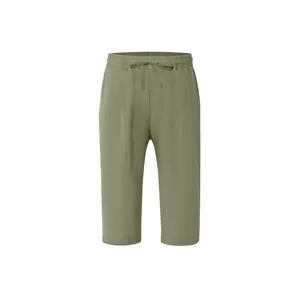 Close-up of olive green men's linen cropped pants with comfortable drawstring waist.