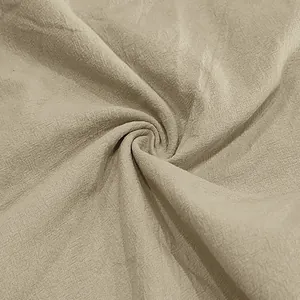 Close-up macro view of breathable beige linen fabric texture for summer men's pants