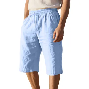 Close-up of men's light blue linen drawstring shorts with loose straight fit