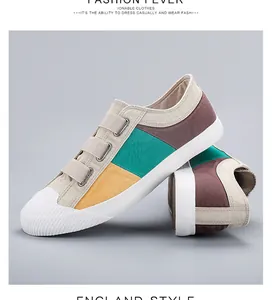 Side view of multi-color canvas slip-on shoes with three velcro straps and white toe
