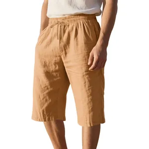 Detail of loose linen men's casual beach shorts with drawstring waist in camel brown
