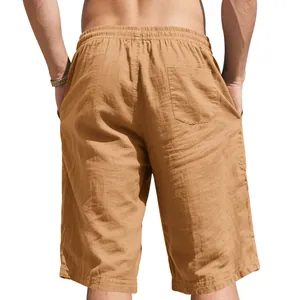 Rear view of men's loose linen shorts in khaki showing texture and back pocket