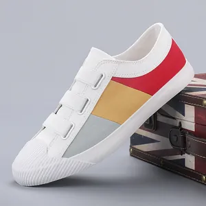Stylish women's slip-on canvas shoes featuring colorful block patterns on a white base