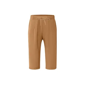 Close-up detailed view of men's camel linen cropped pants with elastic drawstring waist.