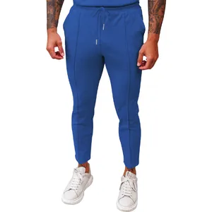 Detailed view of men's blue waffle textured casual trousers with elastic drawstring waist