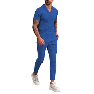 Full body view of royal blue waffle knit polo shirt and matching trousers set