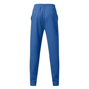 Back view of men's blue waffle knit athletic pants with elastic waist and pockets.