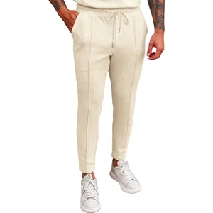 Detail shot of men's cream waffle knit casual trousers with adjustable drawstring
