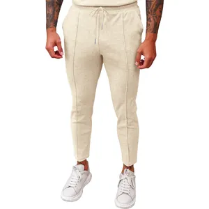 Close-up of beige waffle knit joggers featuring adjustable drawstring and elastic waist.