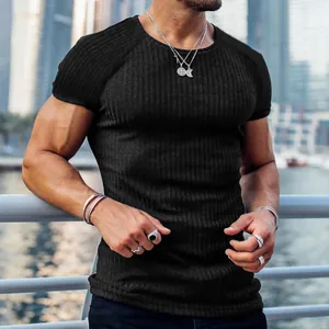 Detail view of men's black ribbed slim-fit T-shirt showing muscle fit and texture