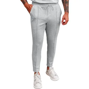 Detail of gray waffle knit joggers with drawstring waist and vertical seam accents