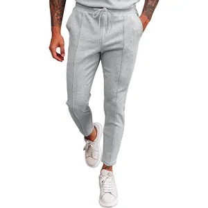 Full-length view of men's grey waffle-knit pants showcasing the fabric texture.
