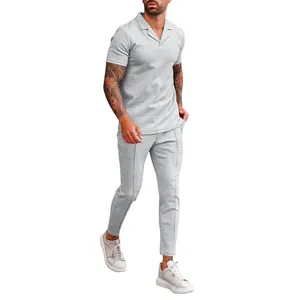 Detail view of men's grey waffle knit casual set with textured polo shirt and pants