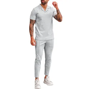 Detail of men's grey waffle knit two-piece set with polo shirt and matching trousers