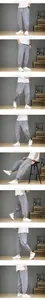 Detail views showing the fit of men's loose cotton linen lantern pants in light grey