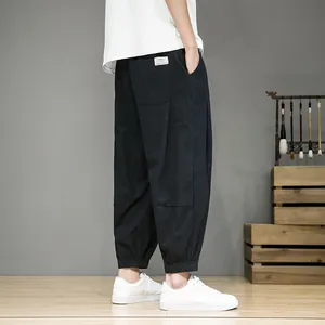 Detailed side view showing the texture of men's navy blue cotton linen cropped pants