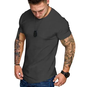 Close-up of a muscular man wearing a slim-fit dark grey crew neck athletic T-shirt.