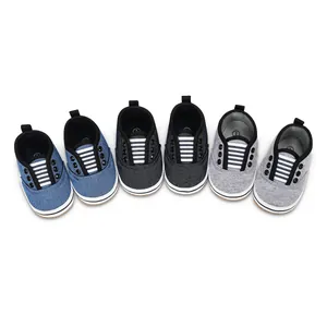 Detailed view of baby walking shoes in denim blue, dark gray, and light gray colors