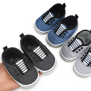 Close-up of baby canvas walking shoes in blue, gray, and black for 0-1 year olds.