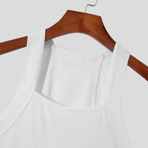Close-up of white ribbed men's tank top neckline and shoulder strap detail