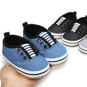 Close-up view of soft-sole canvas baby walker shoes in blue, black, and grey colors