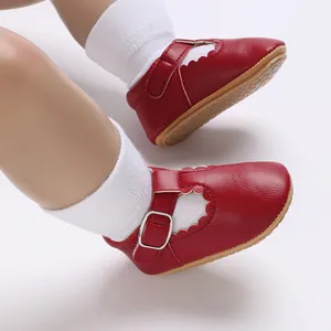 Detail view of red soft-sole baby Mary Jane shoes with scalloped edges for infants