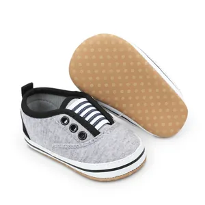 Detailed view of grey baby walking shoes with anti-slip dotted soft sole