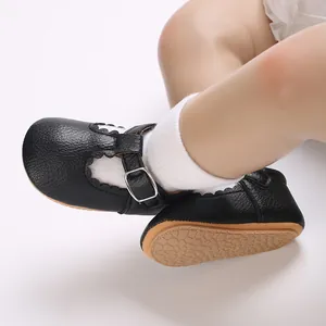 Detailed view of black baby Mary Jane walking shoes with scalloped edges and soft sole.