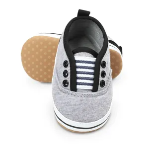 Detailed view of grey soft-sole baby walking shoes with striped elastic band