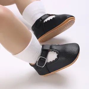 Close-up of black baby Mary Jane walking shoes with scalloped edges and T-strap