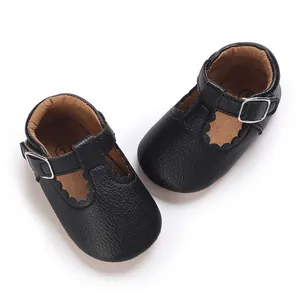 Detailed close-up of black soft-soled baby Mary Jane shoes featuring scalloped edges.