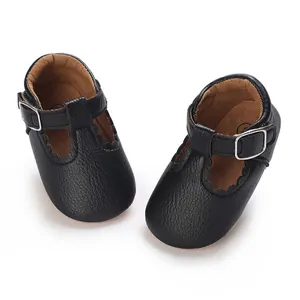 Close-up of black scalloped baby Mary Jane shoes with soft textured leather finish