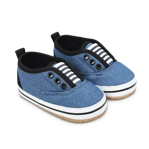 Detailed view of blue denim baby walker shoes with striped tongue and soft sole