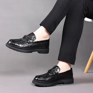 Classic black leather loafers for men with chunky soles and metal bit detail.