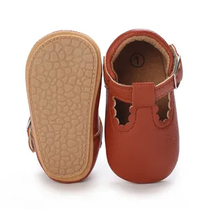 Detail view of soft rubber sole and brown leather upper of baby walking shoes.