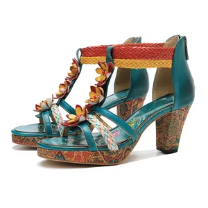 Detailed view of bohemian leather sandals with ethnic floral and woven strap details